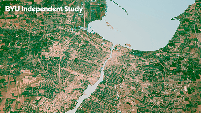aerial photo of land with a river flowing to a lake